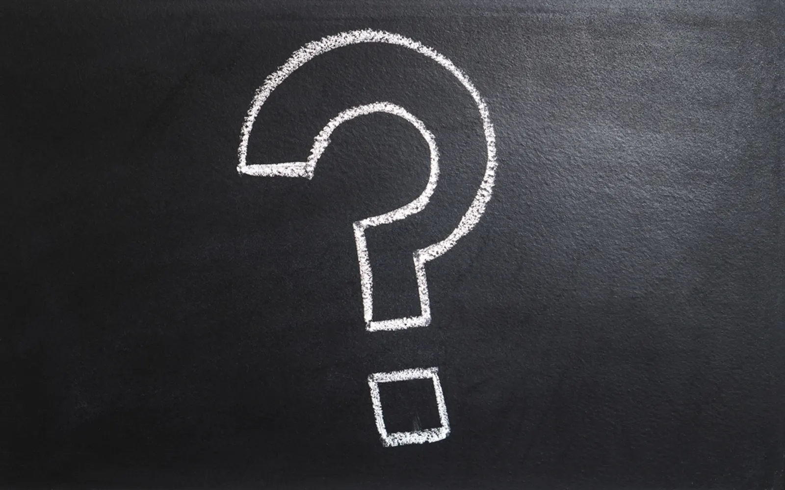 A question mark drawn in chalk on a blackboard