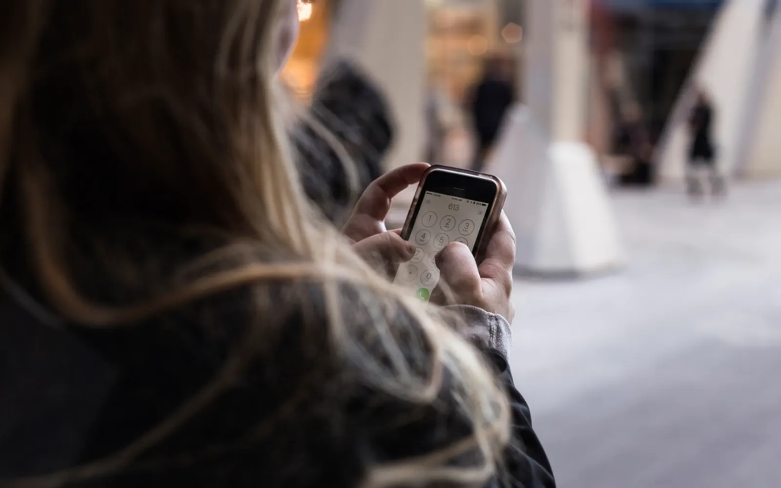 A person checking their phone while out and about